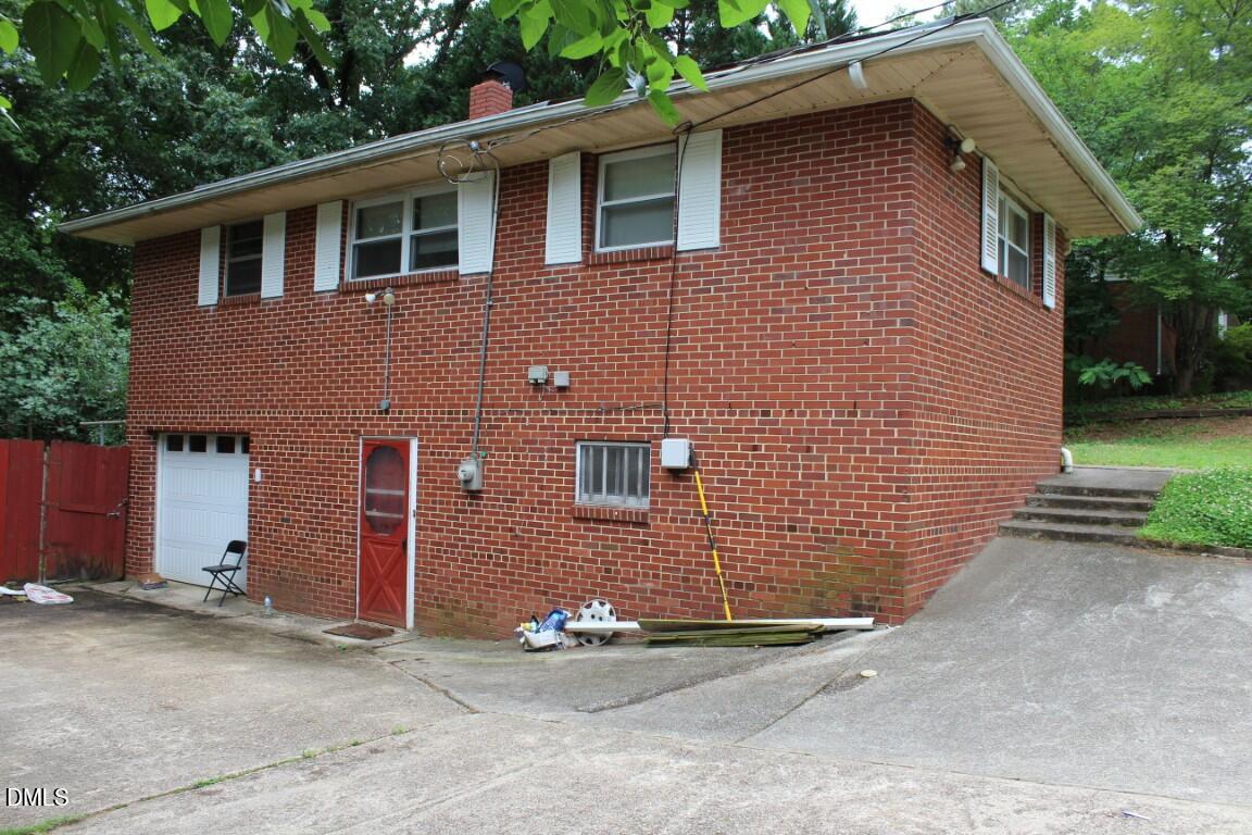 5109 Kaplan Drive Raleigh, NC 27606 - Photo 2 of 13 a front view of a house with a yard and garage