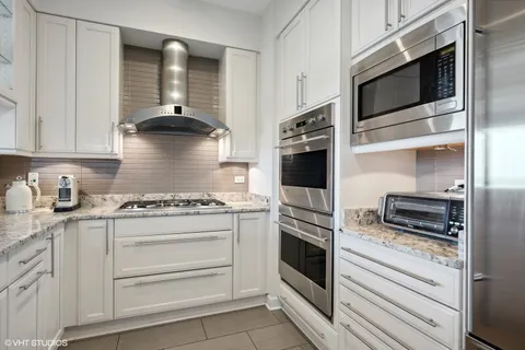 a kitchen with stainless steel appliances granite countertop a stove and a microwave