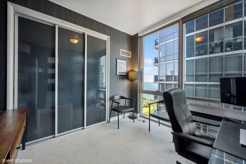 a view of a workspace with furniture and a window