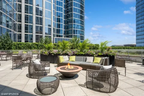 a view of a patio with couches table and chairs and a potted plants