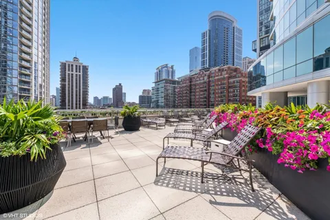 a view of a patio with couches table and chairs and a potted plants
