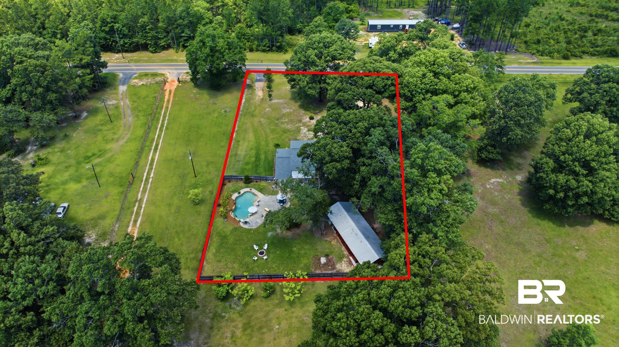 51620 Robert White Road Bay Minette, AL 36507 - Photo 78 of 81 Expansive property featuring a freeform swimming pool, generous green space, and mature trees