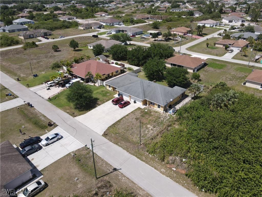 4520 19th Street Southwest Lehigh Acres, FL 33973 - Photo 2 of 11 an aerial view of residential houses with outdoor space