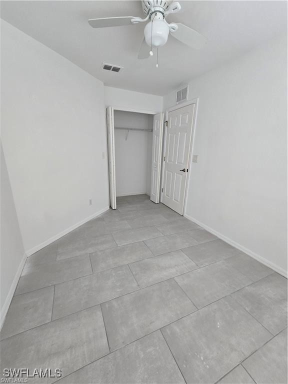 4520 19th Street Southwest Lehigh Acres, FL 33973 - Photo 9 of 11 a view of an empty room with a fan