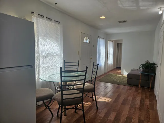 a view of a livingroom with furniture and wooden floor