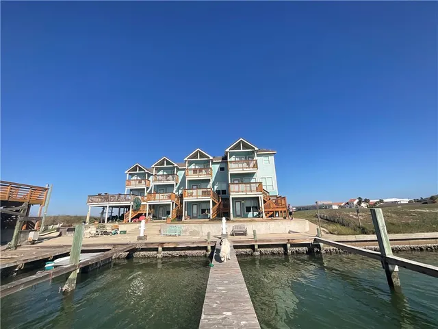 a view of roof deck with table and chairs a barbeque