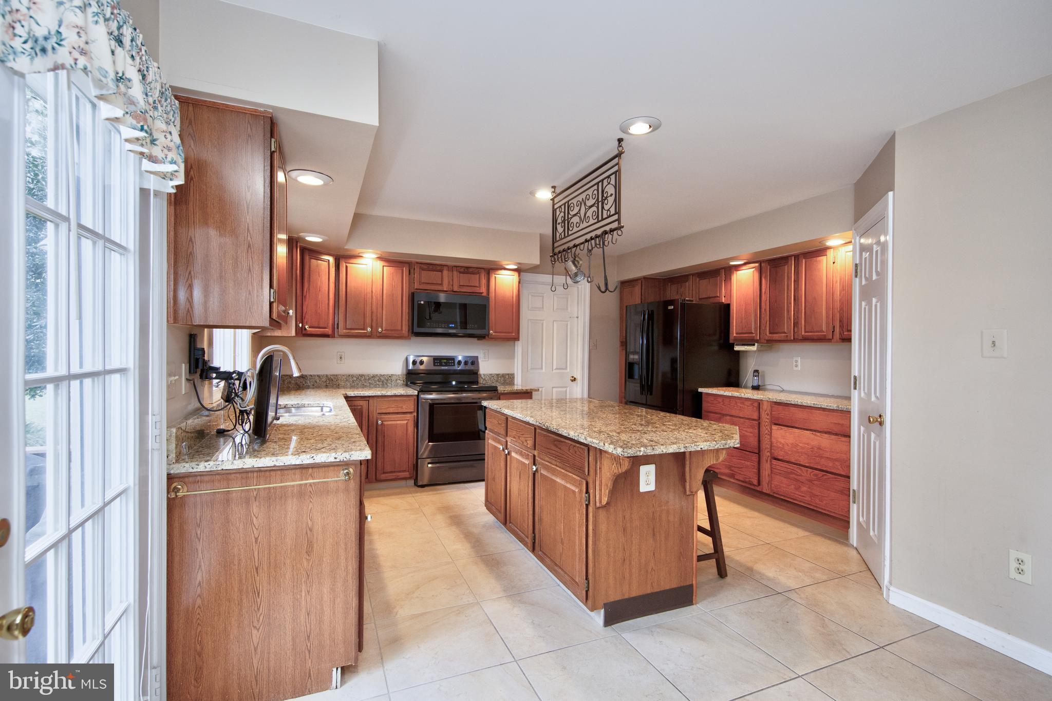 2502 Lady Ann Court Churchville, MD 21028 - Photo 16 of 48 a kitchen with kitchen island stainless steel appliances a sink a stove top oven a counter space and cabinets