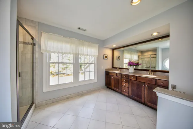 a large kitchen with stainless steel appliances granite countertop a large window