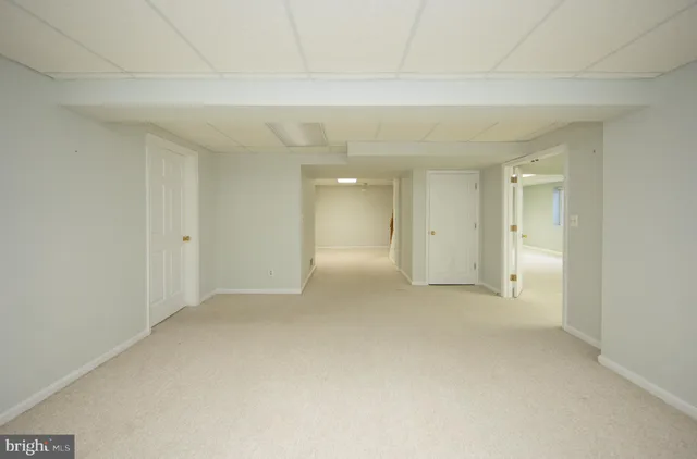 a view of an empty room and a window