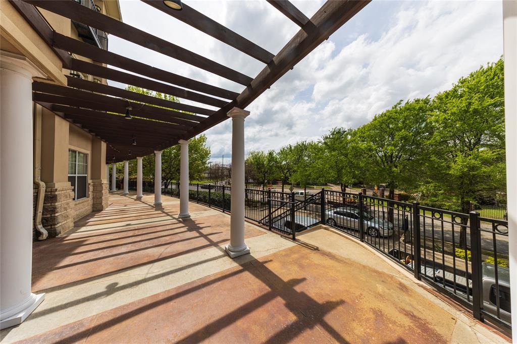 3102 Kings Road, Unit 3310 Dallas, TX 75219 - Photo 18 of 19 a view of a patio with a dining table and chairs with wooden floor and fence