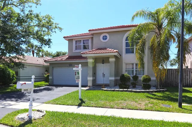 a view of a house with a yard and plants