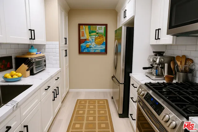 a kitchen with stainless steel appliances granite countertop a stove and a sink