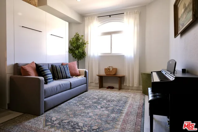 a living room with furniture a window and a lamp