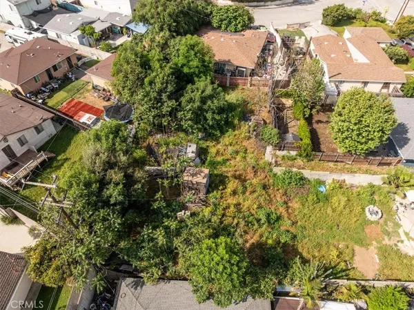an aerial view of residential houses with yard