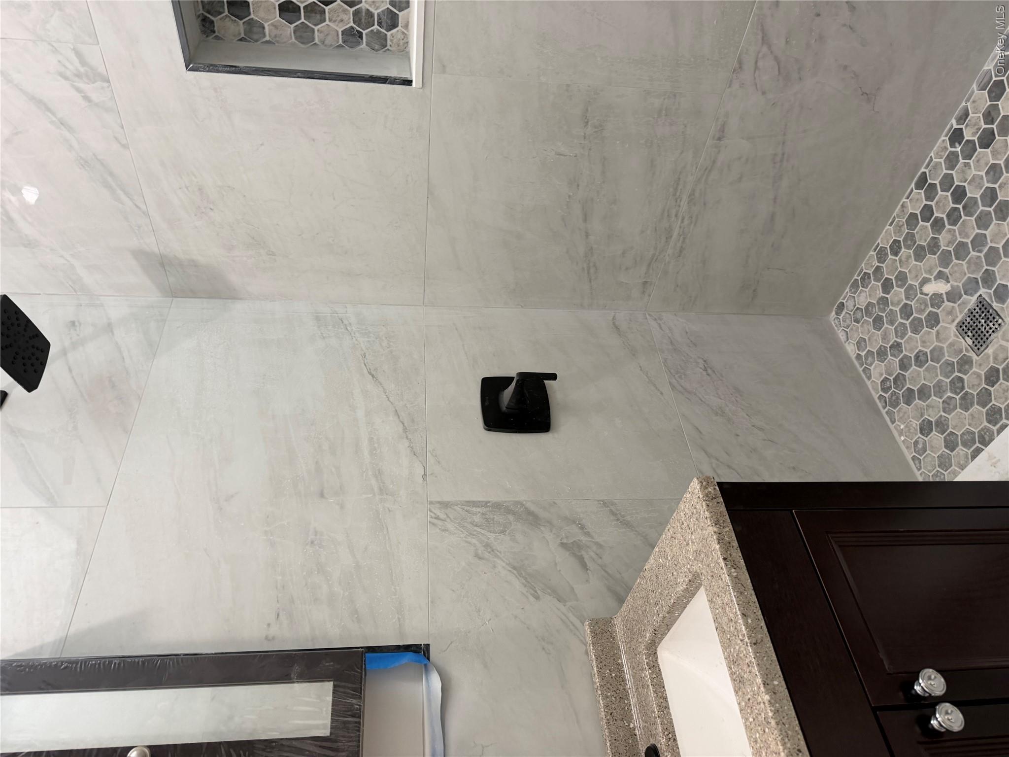 70 Howard Avenue Brooklyn, NY 11221 - Photo 8 of 8 a bathroom with a sink and a mirror