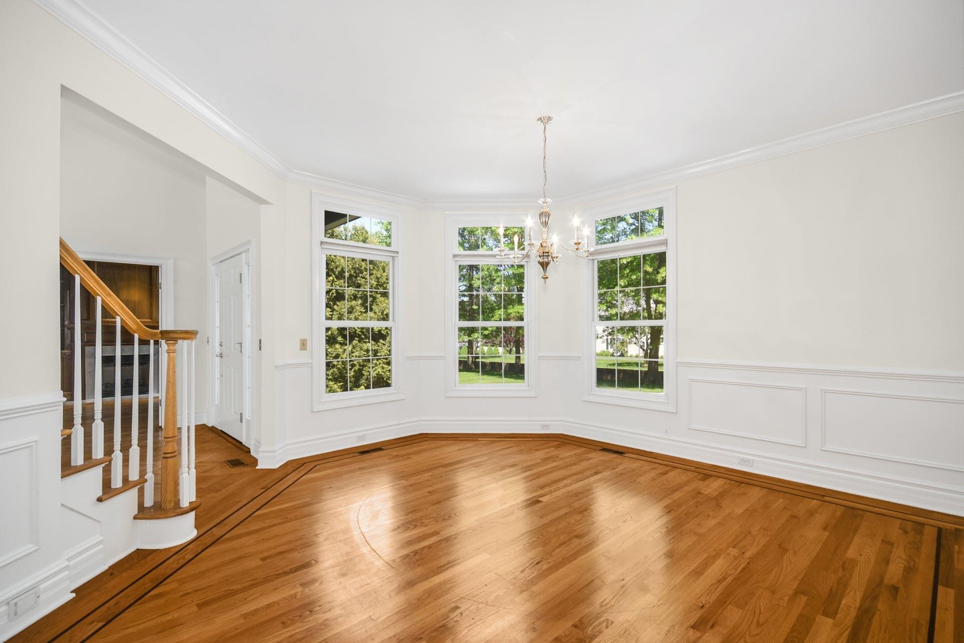 5 Christopher Lane Norwalk, CT 06851 - Photo 13 of 46 a view of a livingroom with wooden floor a ceiling fan and windows