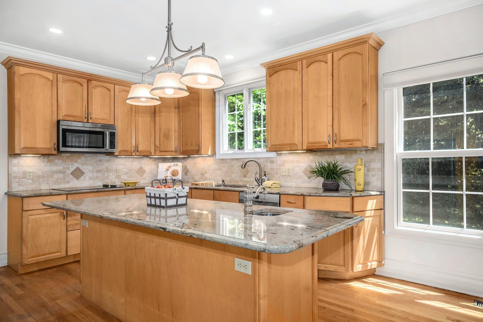 5 Christopher Lane Norwalk, CT 06851 - Photo 17 of 46 a kitchen with stainless steel appliances granite countertop a sink a stove and a microwave