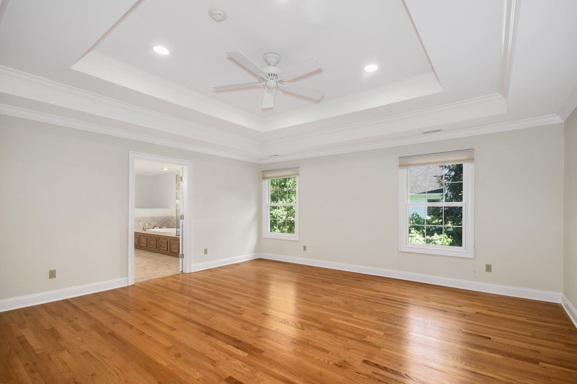 5 Christopher Lane Norwalk, CT 06851 - Photo 22 of 46 an empty room with wooden floor a ceiling fan and windows