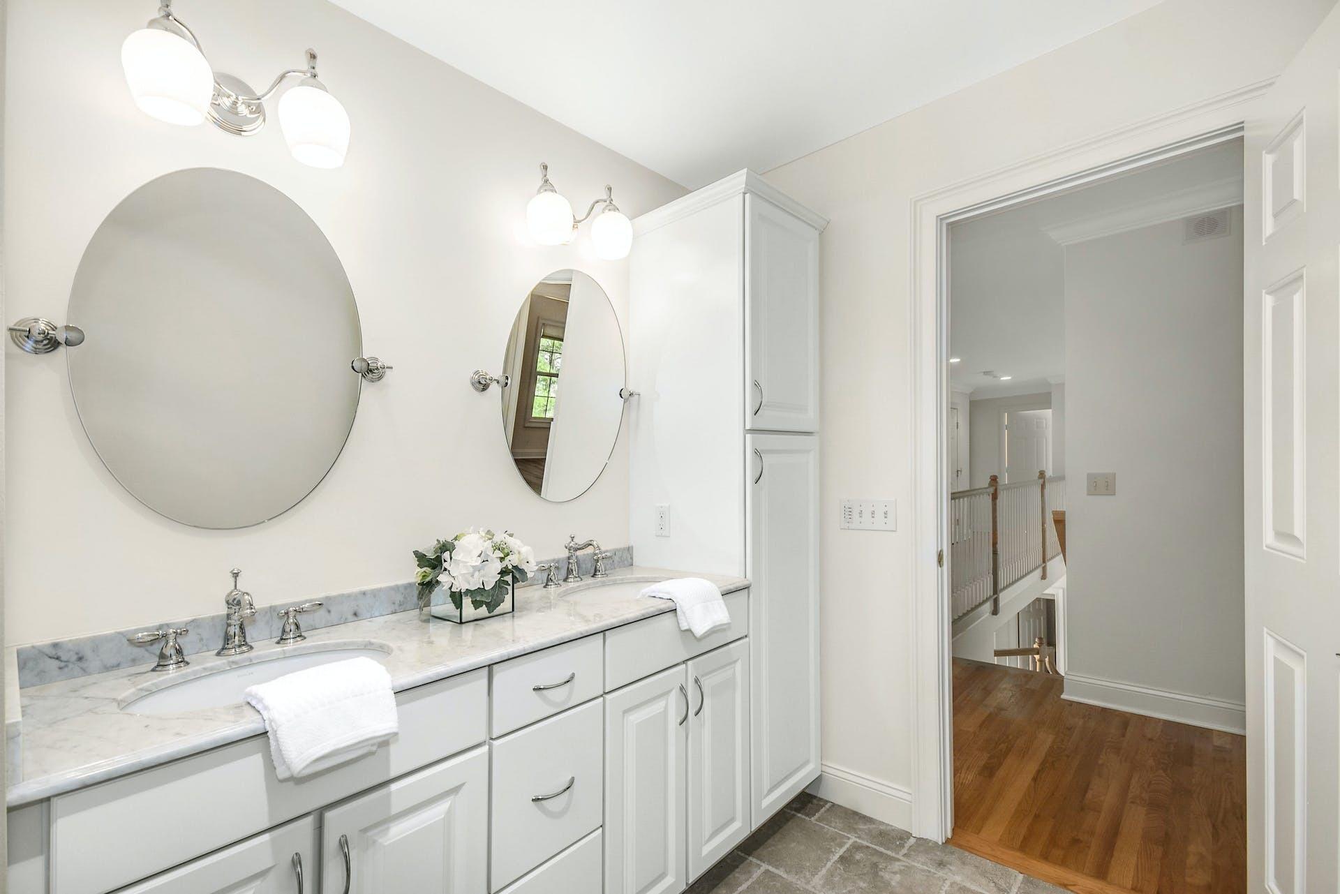 5 Christopher Lane Norwalk, CT 06851 - Photo 26 of 46 a bathroom with double vanity sinks and a mirror