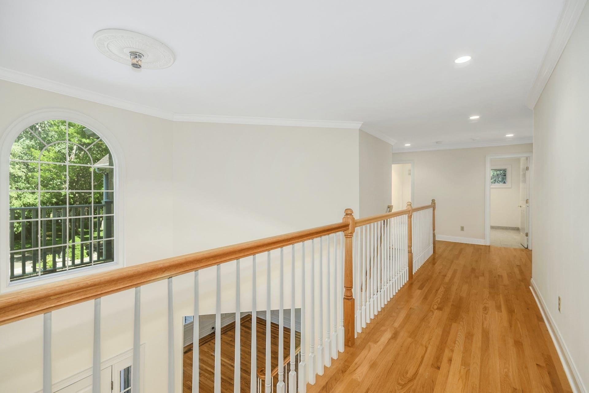 5 Christopher Lane Norwalk, CT 06851 - Photo 29 of 46 a view of a hallway with wooden floor and staircase