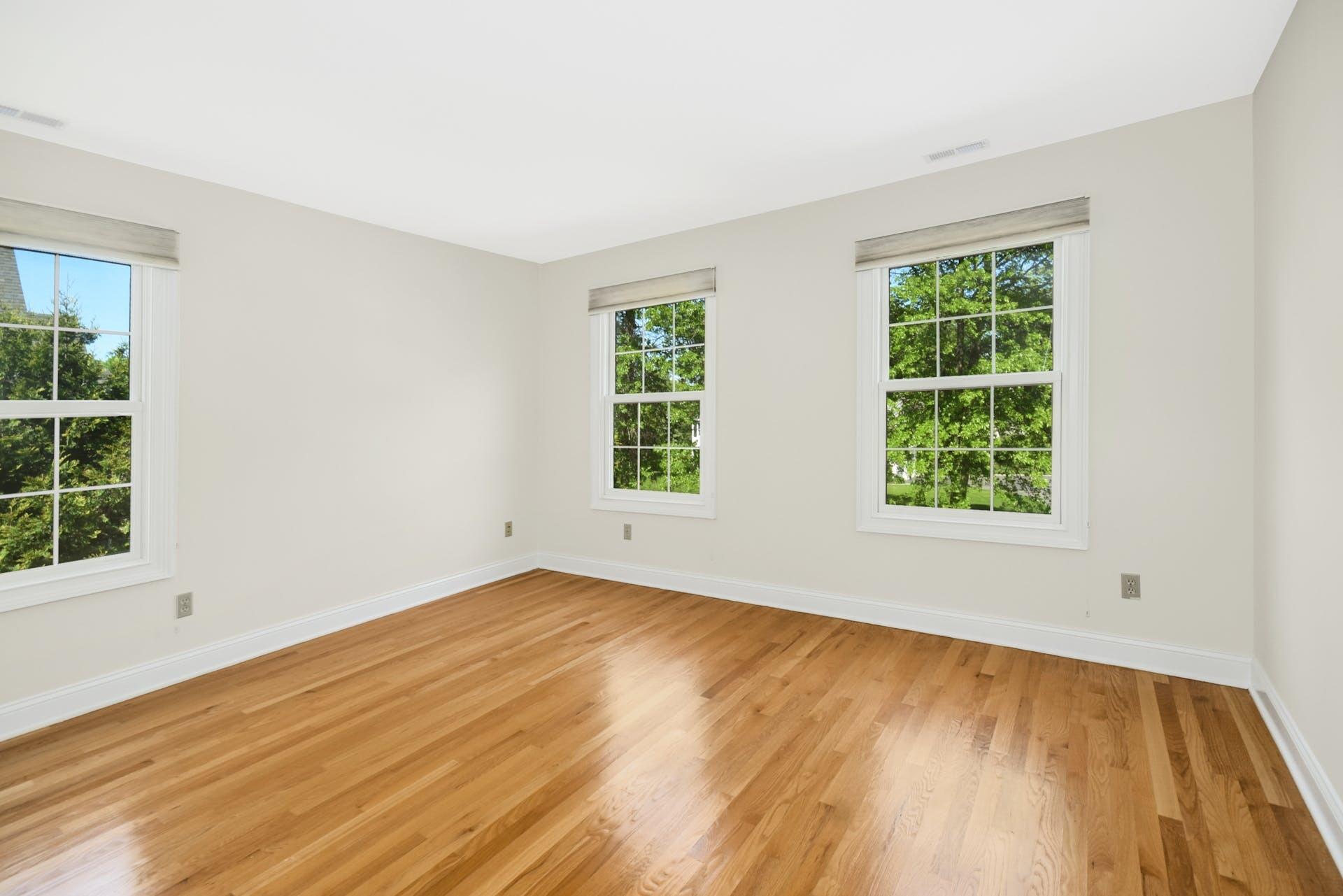 5 Christopher Lane Norwalk, CT 06851 - Photo 30 of 46 a view of an empty room with wooden floor and a window