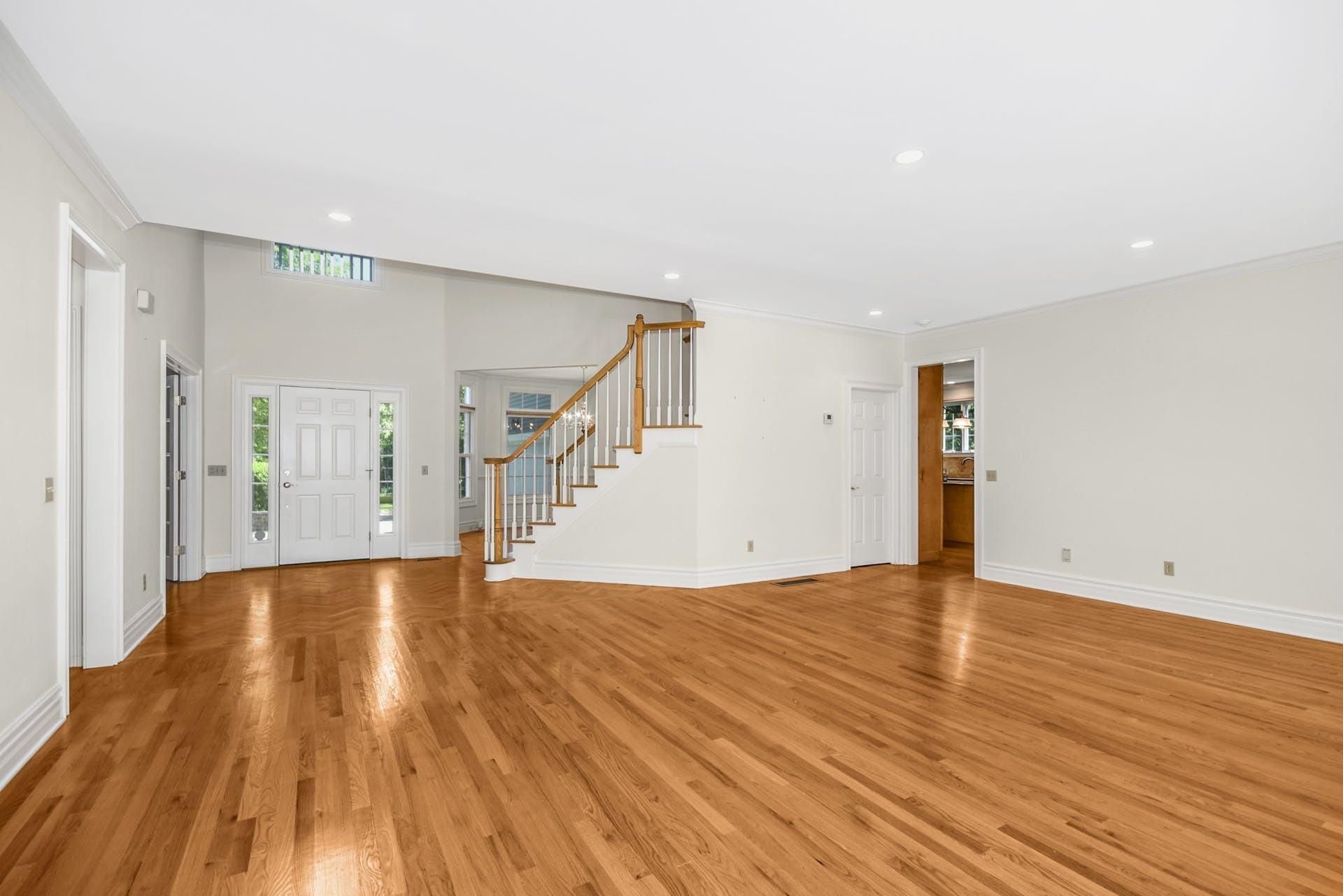 5 Christopher Lane Norwalk, CT 06851 - Photo 7 of 46 a view of an empty room with wooden floor and stairs
