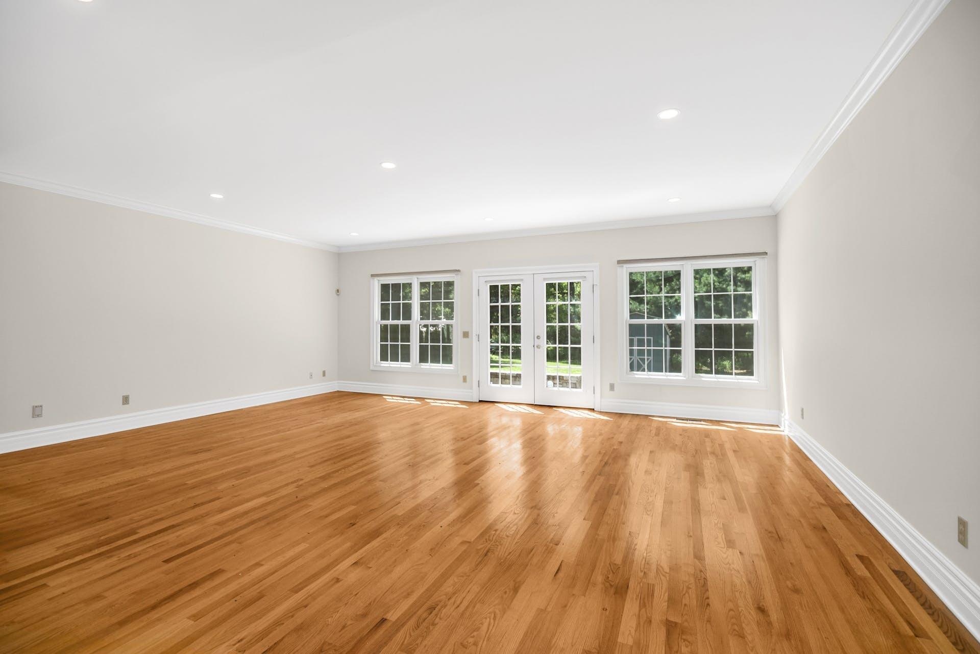 5 Christopher Lane Norwalk, CT 06851 - Photo 9 of 46 a view of an empty room with wooden floor and a window