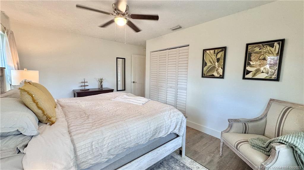 323 Southwest Ridge Lane Stuart, FL 34994 - Photo 18 of 29 a bedroom with a bed couch and window