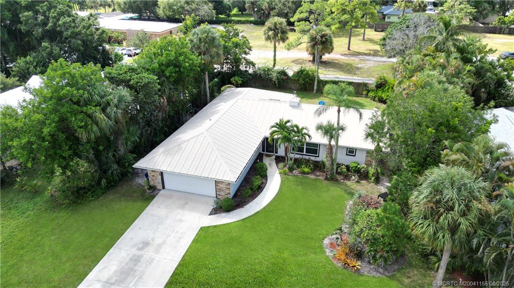 323 Southwest Ridge Lane Stuart, FL 34994 - Photo 22 of 29 a view of a house with a yard and potted plants