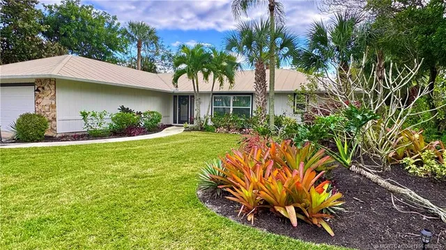 a house view with a sitting space and garden