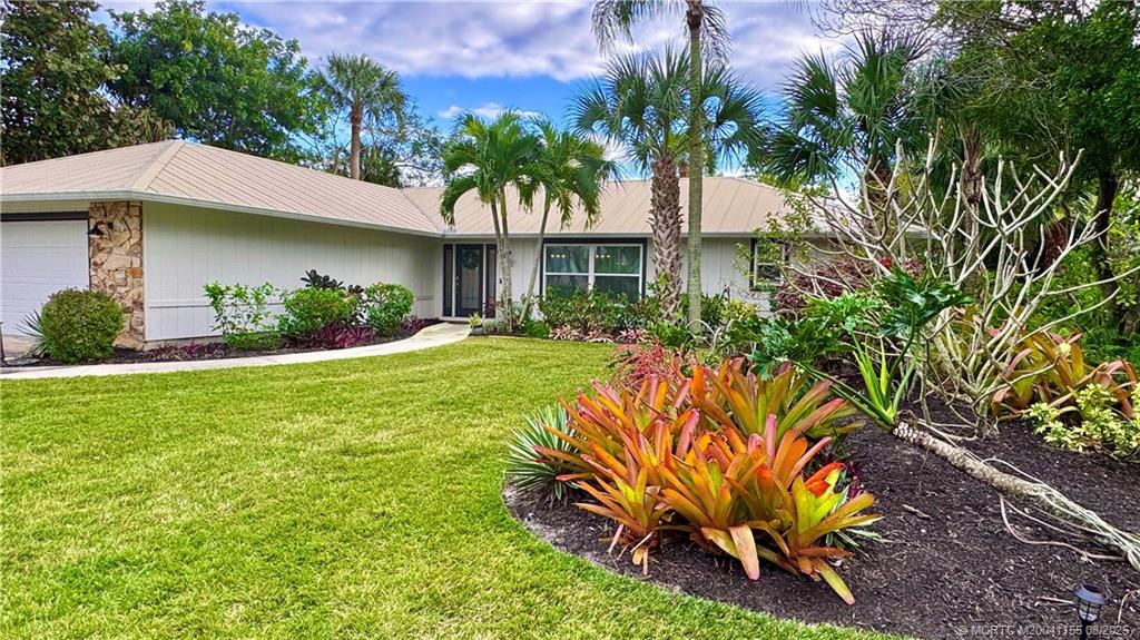 323 Southwest Ridge Lane Stuart, FL 34994 - Photo 25 of 29 a view of a house with a yard and sitting area