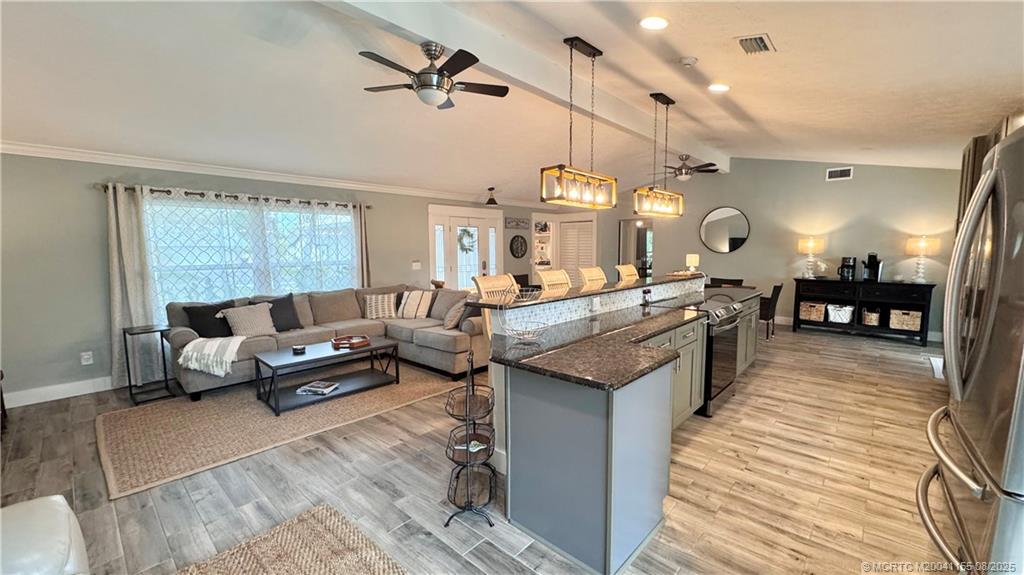 323 Southwest Ridge Lane Stuart, FL 34994 - Photo 8 of 29 a living room with furniture and a large window