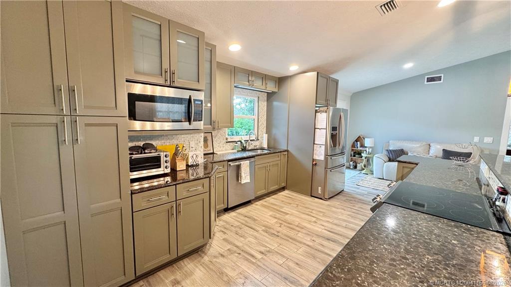 323 Southwest Ridge Lane Stuart, FL 34994 - Photo 10 of 29 a kitchen with a sink microwave and refrigerator