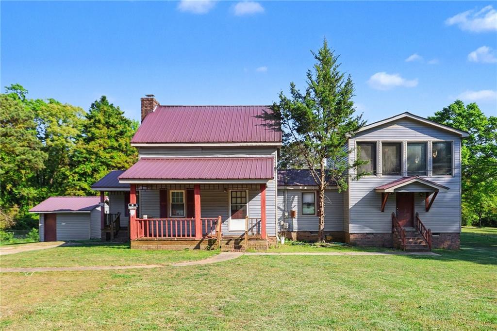 a front view of a house with a garden and porch