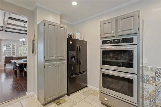 a kitchen with cabinets and steel stainless steel appliances