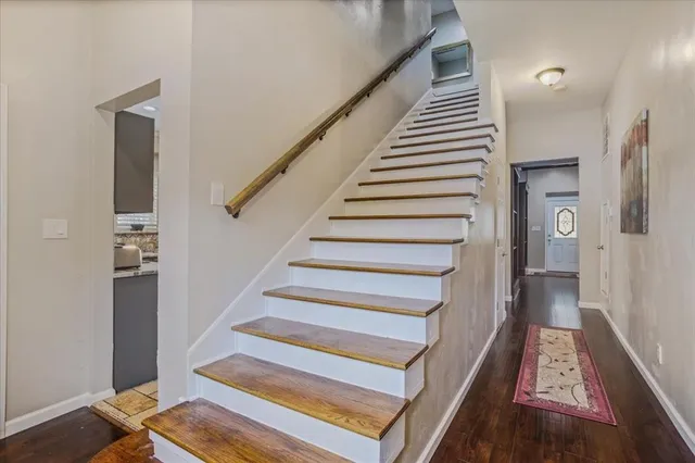 a view of entryway and hall with wooden floor