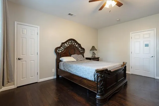a bedroom with a bed and wooden floor