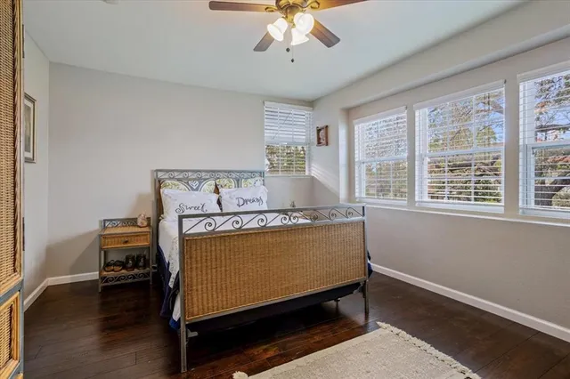 a bed sitting in a bedroom next to a window