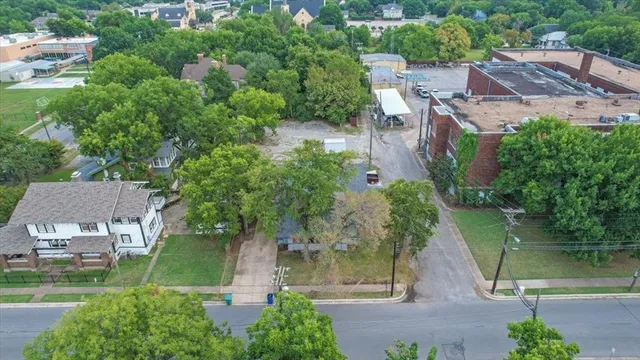 an aerial view of a house with garden space and a lake view