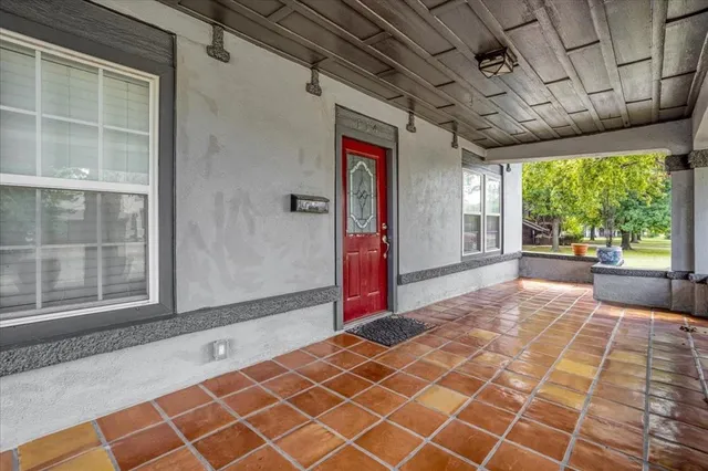 a bedroom with a bed and a large window with balcony view
