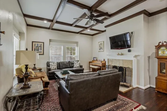 a living room with fireplace furniture and a flat screen tv