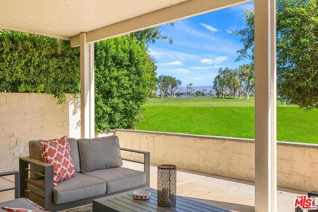 a view of a patio with a table and chairs
