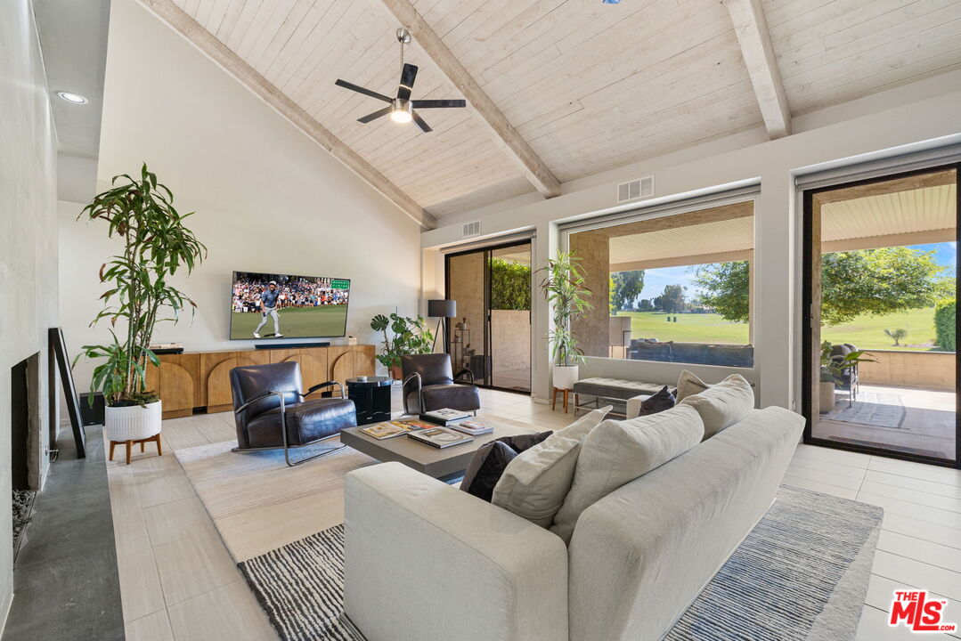 155 Desert W Drive Rancho Mirage, CA 92270 - Photo 11 of 50 a living room with furniture and a large window