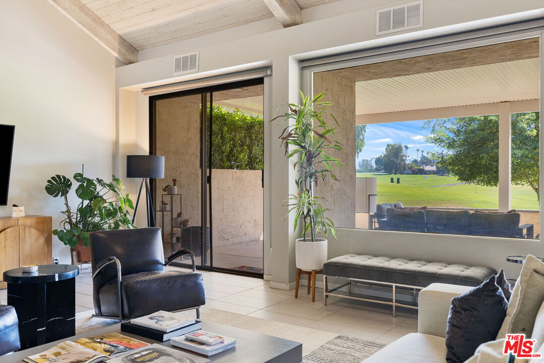 155 Desert W Drive Rancho Mirage, CA 92270 - Photo 16 of 50 a living room with furniture and a window