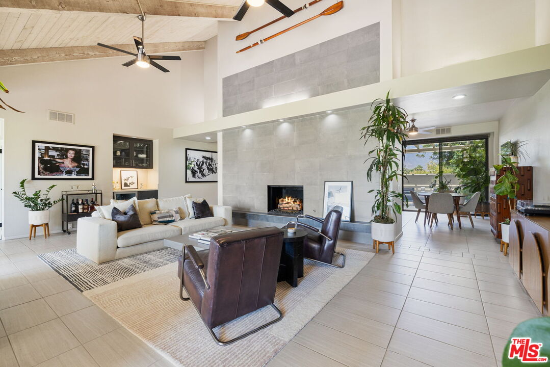 155 Desert W Drive Rancho Mirage, CA 92270 - Photo 17 of 50 a living room with furniture large window and a fireplace