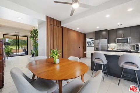 a kitchen with stainless steel appliances kitchen island granite countertop a refrigerator and a stove top oven