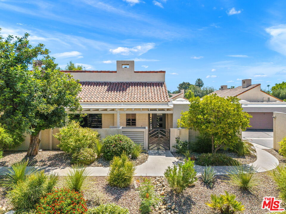 155 Desert W Drive Rancho Mirage, CA 92270 - Photo 2 of 50 a front view of a house with a yard
