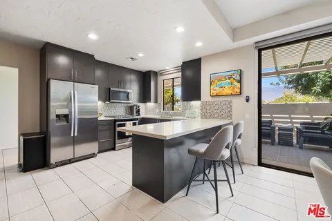 a kitchen with stainless steel appliances granite countertop a stove and a refrigerator