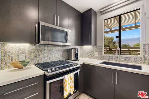 a kitchen with a sink and a mirror