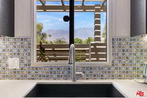 a view of a hallway with furniture and front door